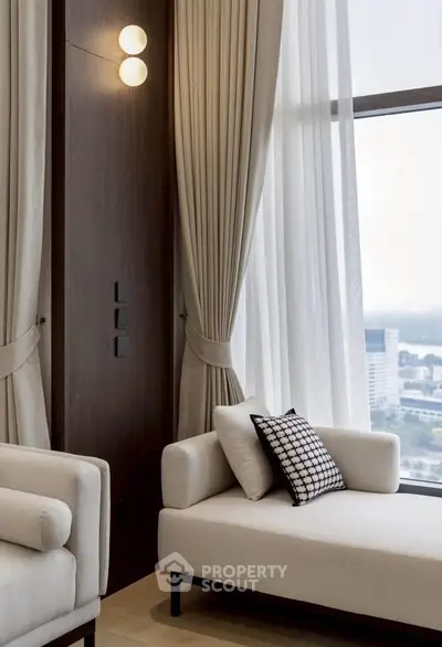 Luxurious modern living room with elegant curtains and city view, featuring stylish white sofas and chic decor.