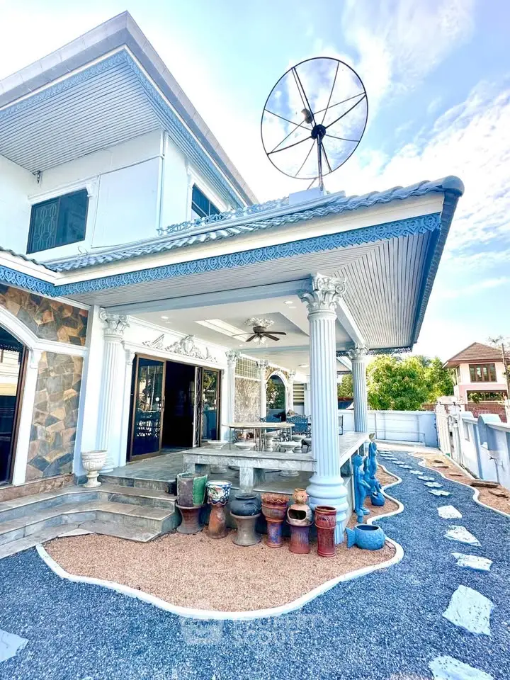 Stunning two-story home with elegant columns and spacious outdoor area, perfect for entertaining.