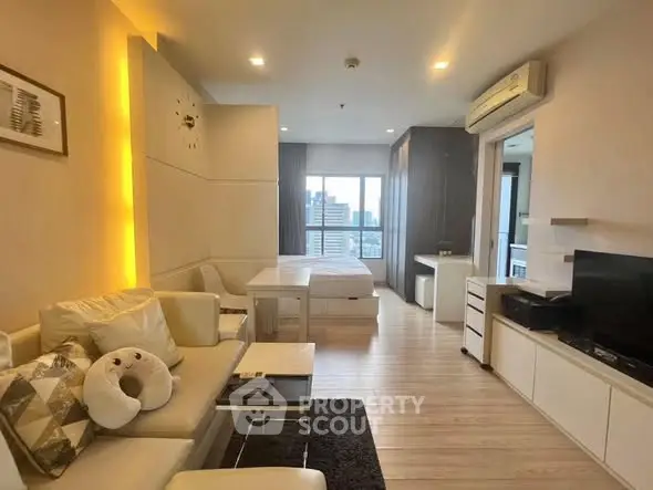 Modern open-plan living room with cozy seating and city view