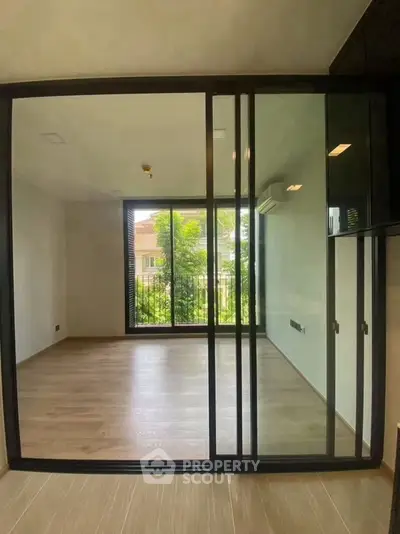 Spacious modern room with large glass doors and garden view