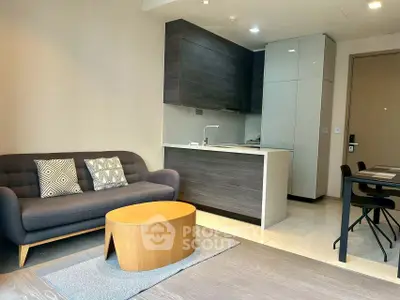 Modern living room with sleek kitchen and stylish furniture