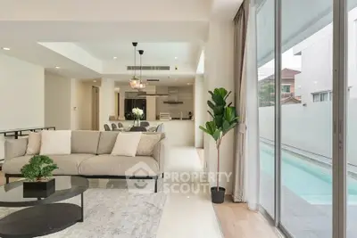 Spacious modern living room with pool view and elegant decor