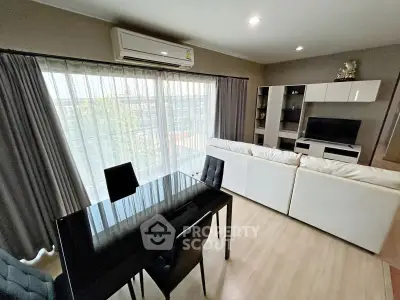 Modern living room with sleek furniture and large window view