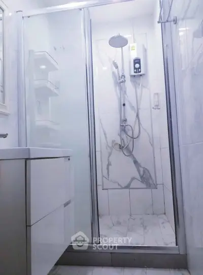 Modern bathroom with sleek shower and elegant marble tiles