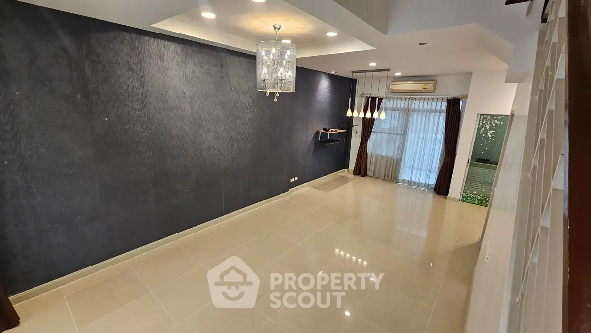 Spacious modern living room with elegant lighting and large windows for natural light.