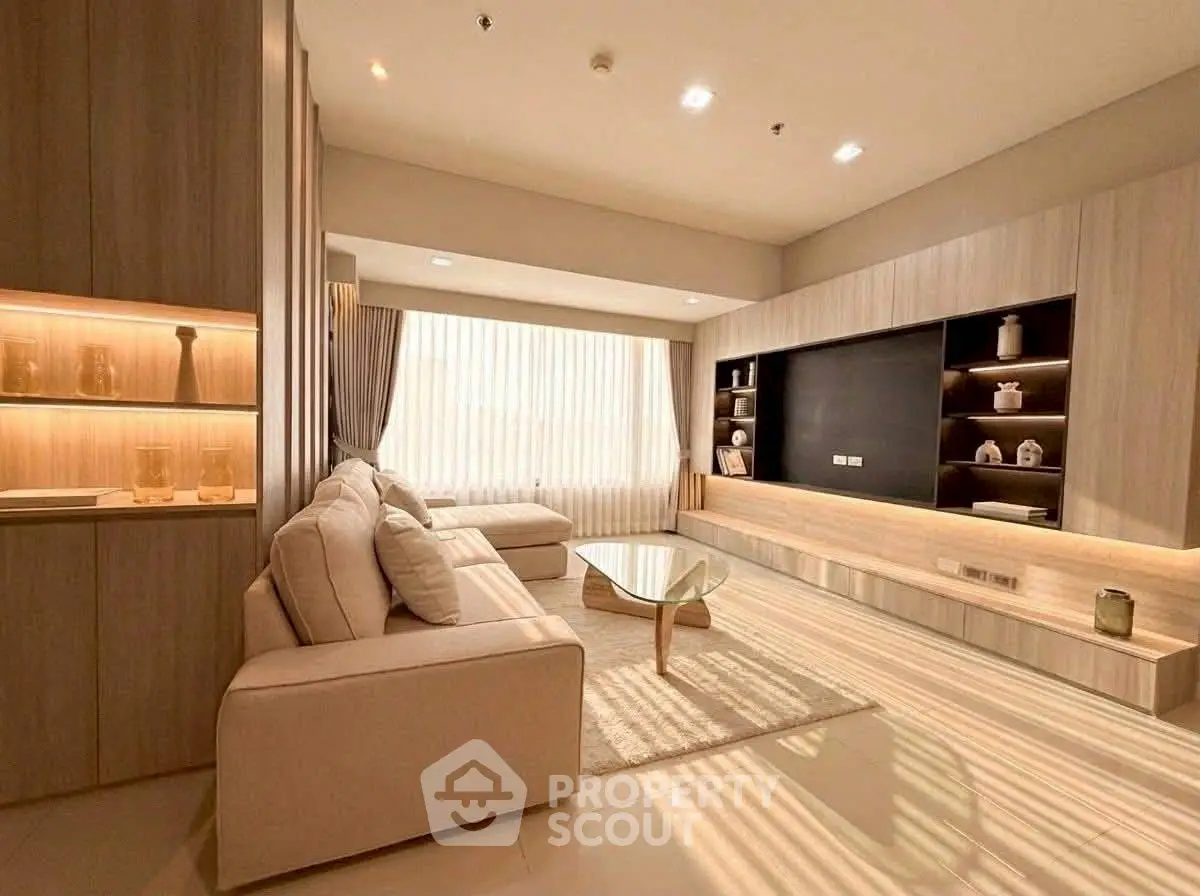 Luxurious modern living room with elegant decor and ample natural light.