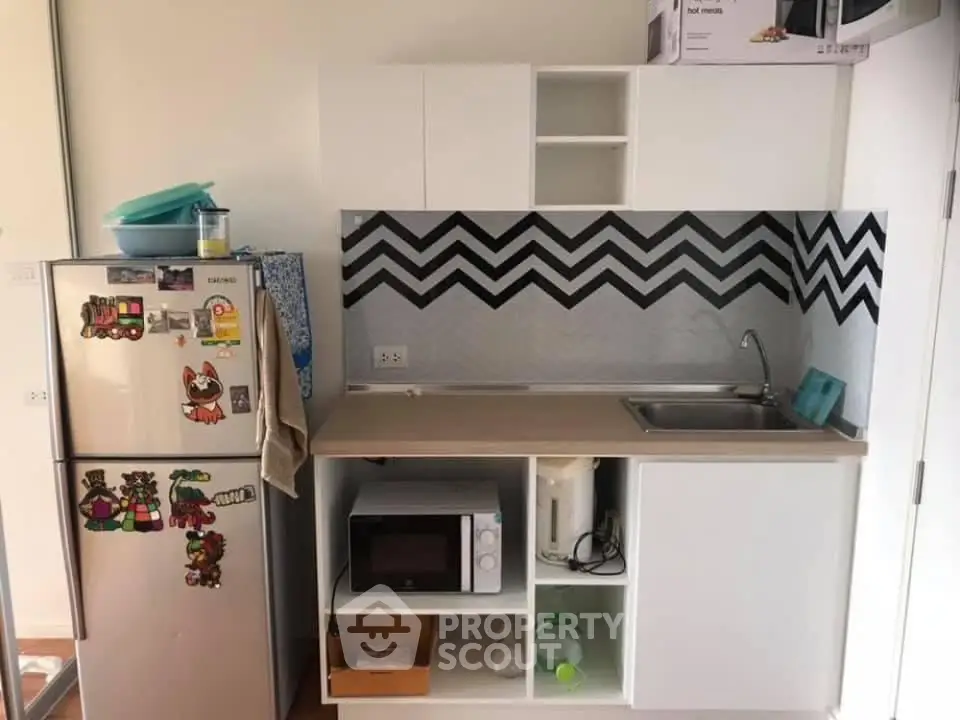 Modern compact kitchen with stylish backsplash and appliances