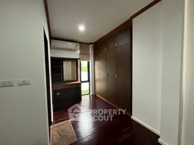 Spacious bedroom with built-in wardrobe and wooden flooring