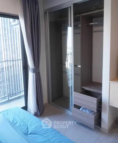 Modern bedroom with built-in wardrobe and balcony view