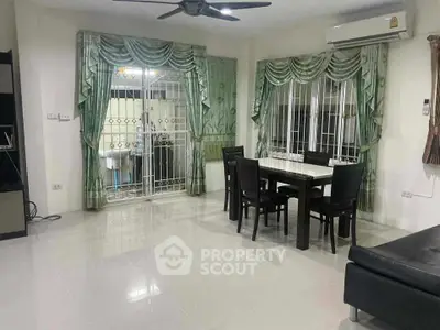 Spacious living room with elegant dining area and modern furnishings, perfect for family gatherings.