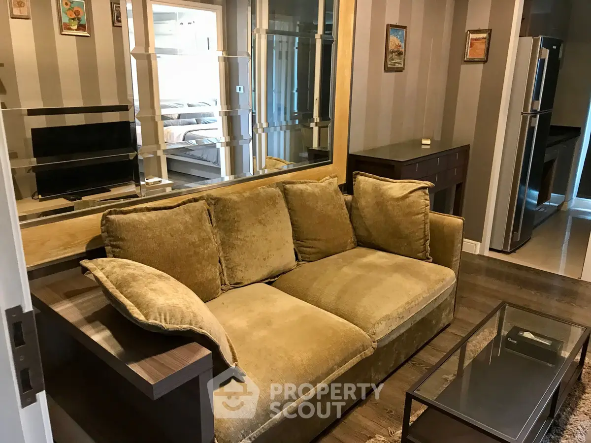Stylish living room with plush sofa and modern decor in a cozy apartment setting.