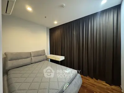 Modern bedroom with cozy bed and elegant curtains in a stylish apartment.