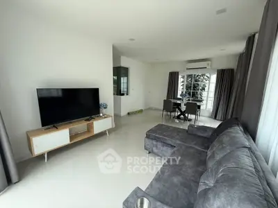 Spacious modern living room with sleek furniture and large windows for natural light.