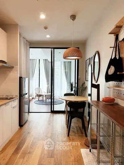 Stylish open-plan kitchen and living area with modern decor and natural light.