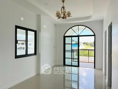 Spacious living room with large window and modern chandelier