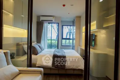 Modern bedroom with large windows and stylish decor in a luxury apartment.
