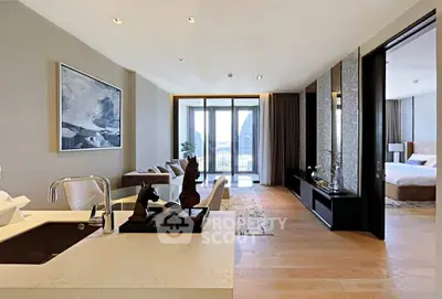 Luxurious open-plan living room with modern decor and stunning view, featuring elegant furnishings and natural light.