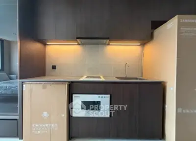 Modern kitchen with sleek cabinetry and built-in appliances in a compact layout.