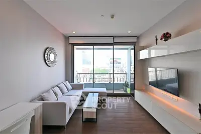 Modern living room with sleek furniture and balcony view in urban apartment