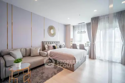 Modern studio apartment with stylish decor and large windows for natural light.