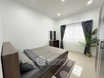 Spacious modern bedroom with natural light and stylish decor
