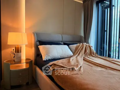 Luxurious bedroom with cozy lighting and modern decor, featuring a plush bed and elegant side table.