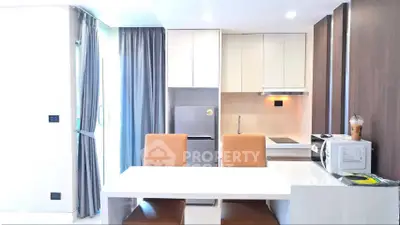 Modern kitchen with sleek design, featuring a dining area, built-in appliances, and stylish cabinetry.
