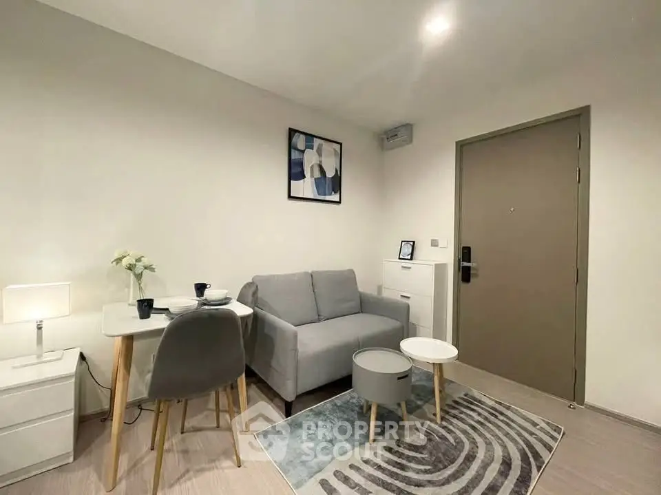 Modern living room with cozy sofa, stylish decor, and compact dining area in a contemporary apartment.