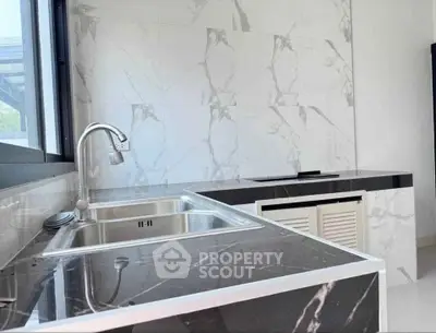 Modern kitchen with sleek marble countertops and stainless steel sink