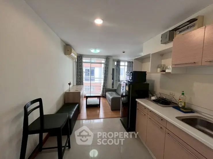 Modern studio apartment with open kitchen and cozy living area, perfect for urban living.