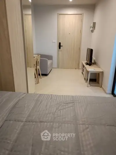 Cozy studio apartment with modern furnishings and neutral decor, perfect for urban living.