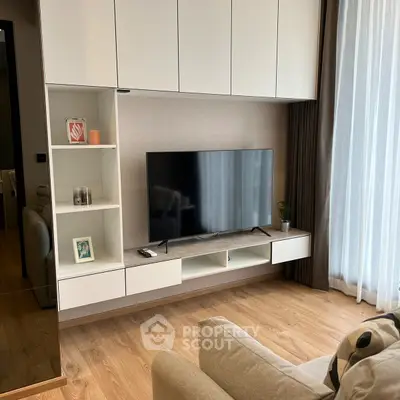 Modern living room with sleek TV unit and cozy seating area