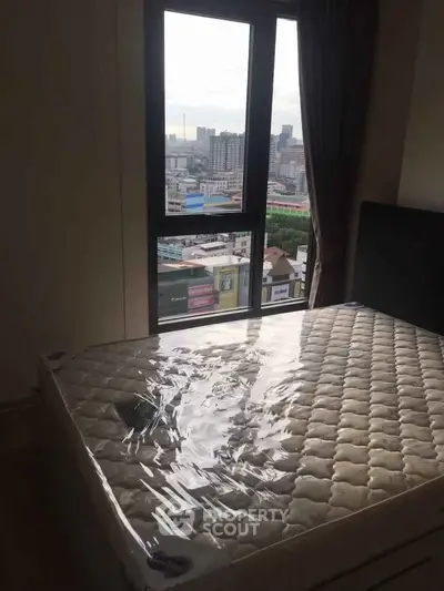 Cozy bedroom with city view and new mattress in modern apartment