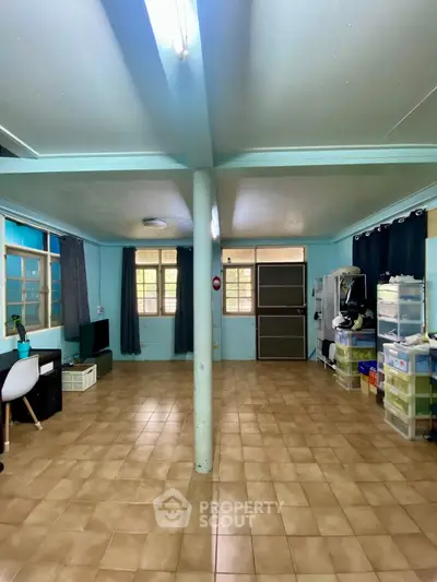 Spacious living room with tiled flooring and natural light, ideal for customization.