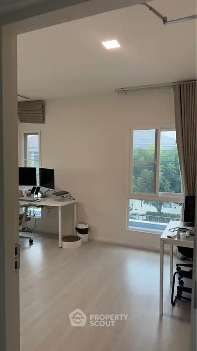 Modern home office with large windows and minimalist decor