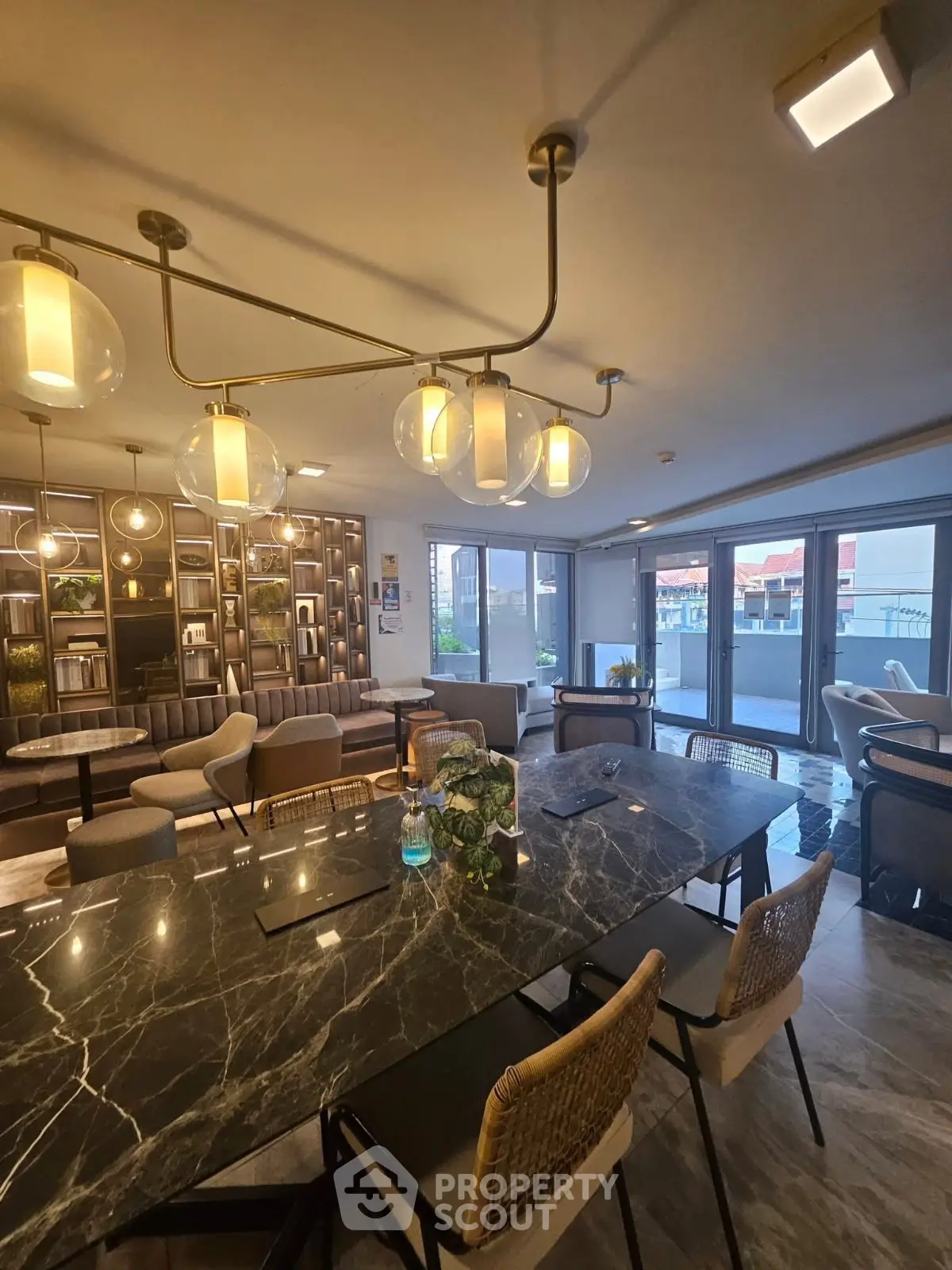 Luxurious modern living room with elegant lighting and spacious balcony access.