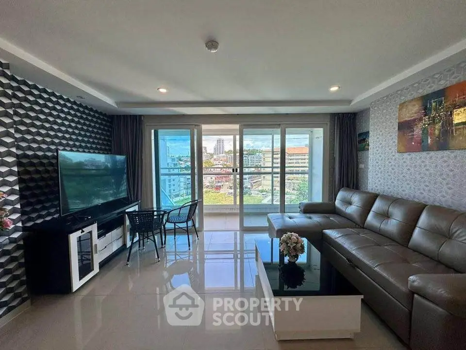 Spacious modern living room with large windows and city view