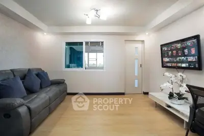 Modern living room with sleek sofa and stylish decor, perfect for relaxation and entertainment.