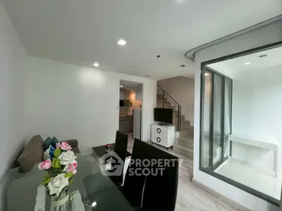 Modern living room with dining area and staircase in stylish apartment
