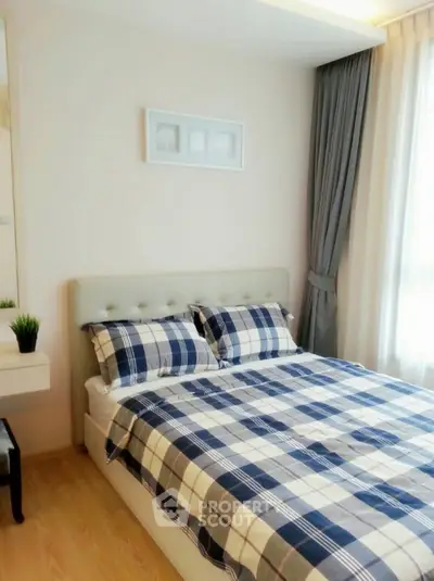 Cozy bedroom with stylish decor and natural light, perfect for relaxation and comfort.