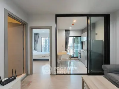 Modern open-plan living room with kitchen and bedroom view