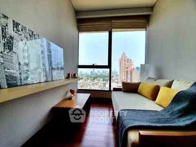 Modern living room with city view, cozy sofa, and stylish decor in high-rise apartment.