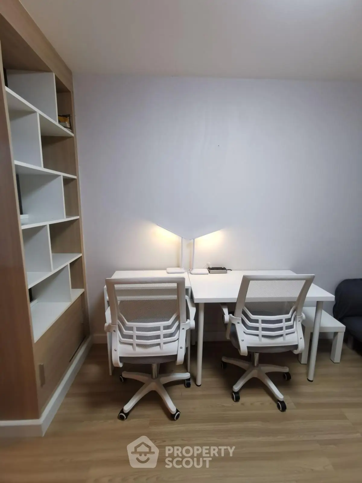 Modern study room with sleek white desks and chairs, perfect for productivity.