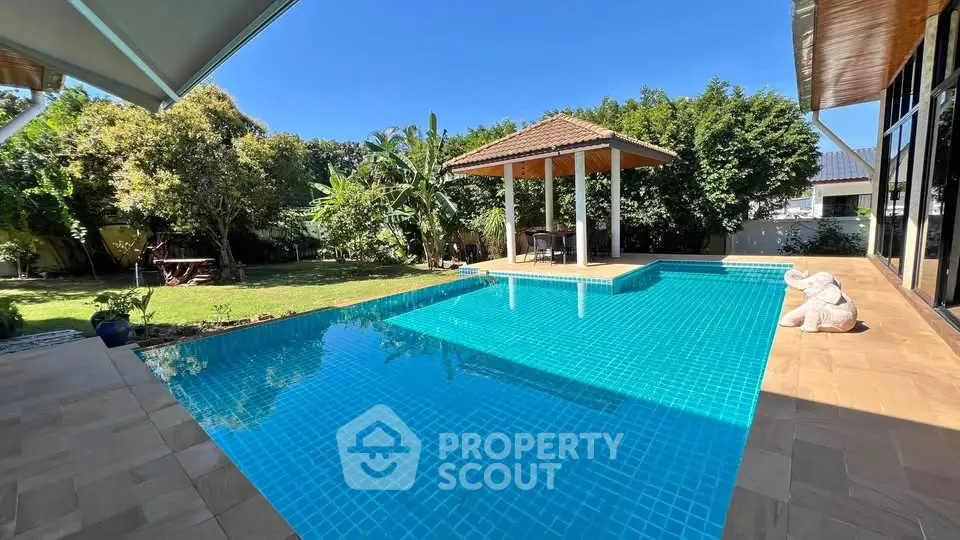 Luxurious outdoor pool with gazebo in a serene garden setting, perfect for relaxation and entertainment.