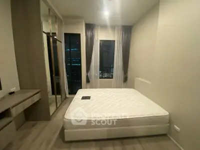 Modern bedroom with large windows and minimalist design in urban apartment