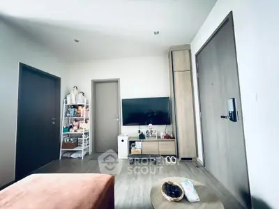 Modern living room with sleek TV setup and stylish storage solutions.