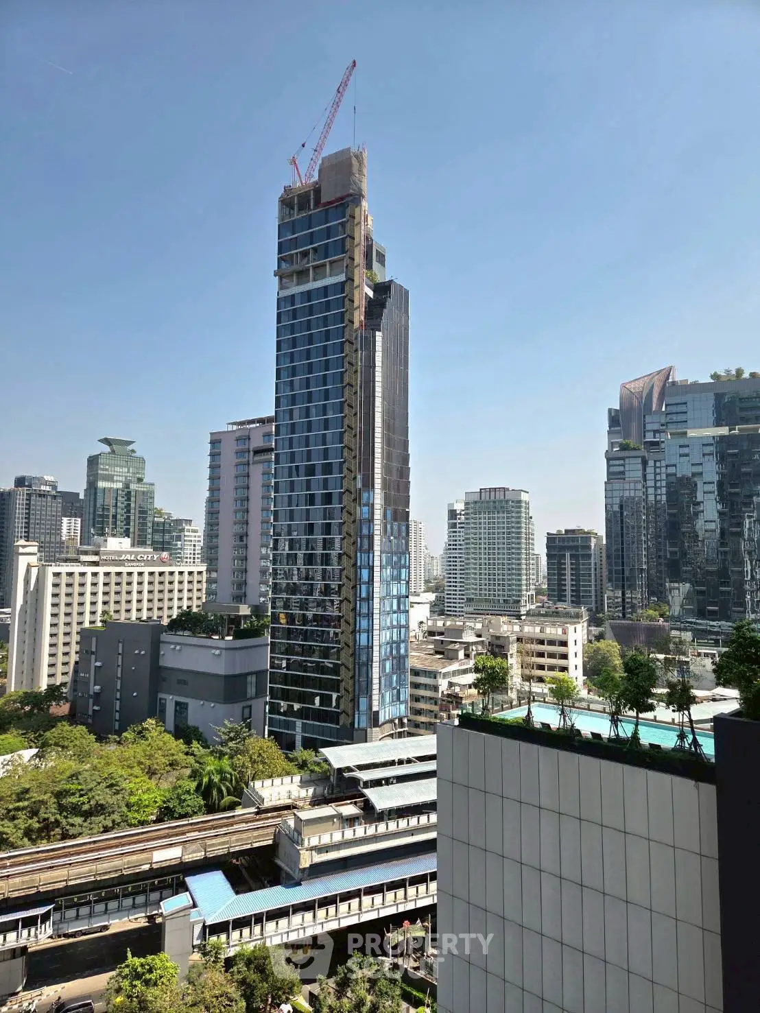 Stunning cityscape view featuring modern high-rise buildings and lush greenery, perfect for urban living.