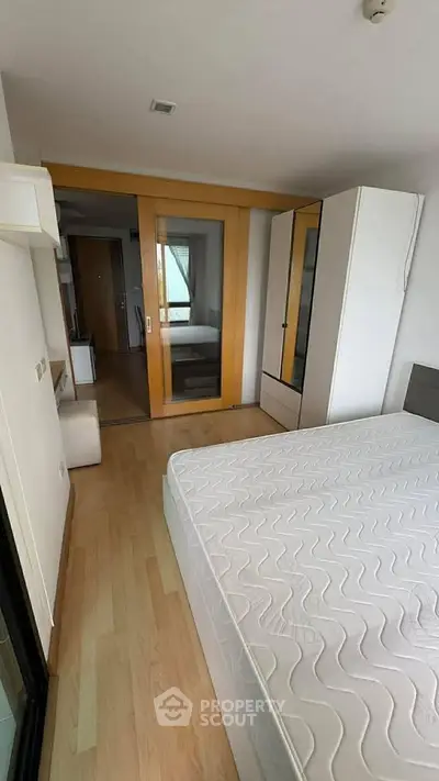 Spacious bedroom with modern sliding doors and ample natural light