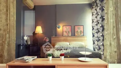 Stylish bedroom with modern decor and cozy ambiance, featuring elegant lighting and artistic wall art.