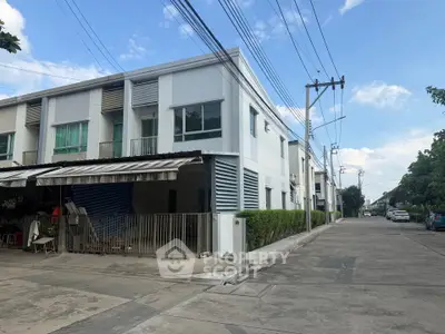 Modern townhouse corner unit with sleek design and spacious driveway in a serene neighborhood.
